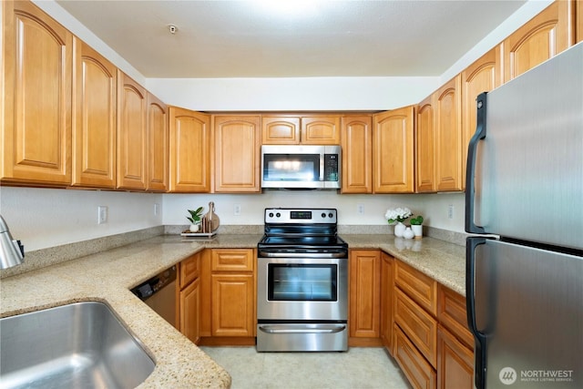11130 SE 208th St Unit K101, Kent, WA 98031 - kitchen with appliances with stainless steel finishes, light stone counters, and brown cabinets