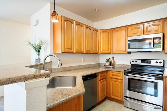 11130 SE 208th St Unit K101, Kent, WA 98031 - kitchen featuring stainless steel appliances, light stone countertops, a peninsula, decorative light fixtures, and brown cabinetry