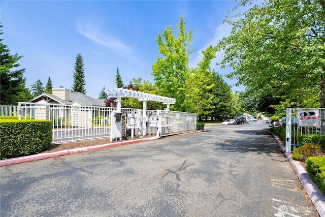 11130 SE 208th St Unit K101, Kent, WA 98031 - view of asphalt road featuring curbs and a gated entry