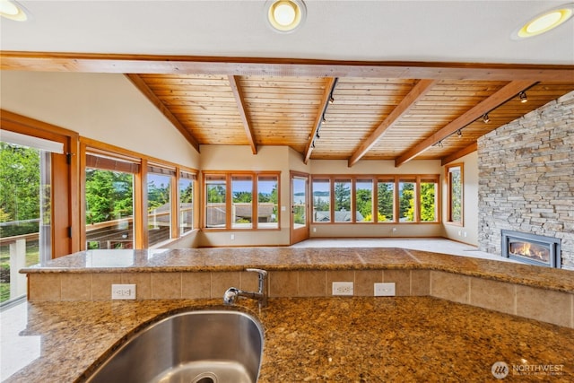705 Shelter Bay Dr, La Conner, WA 98257 - kitchen with wooden ceiling, a stone fireplace, open floor plan, and stone counters