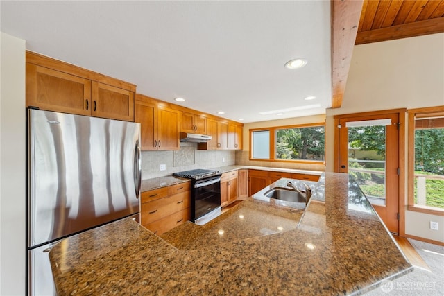 705 Shelter Bay Dr, La Conner, WA 98257 - kitchen with freestanding refrigerator, stove, under cabinet range hood, recessed lighting, and backsplash