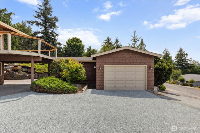 705 Shelter Bay Dr, La Conner, WA 98257 - view of front facade with an attached garage and gravel driveway