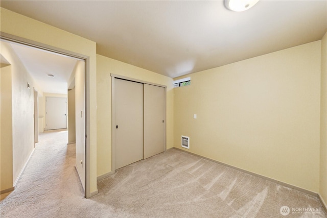 705 Shelter Bay Dr, La Conner, WA 98257 - unfurnished bedroom featuring light carpet, a closet, and heating unit