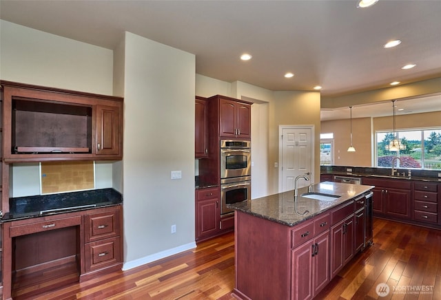 8025 Columbia Way NE, Lacey, WA 98516 - kitchen featuring stainless steel double oven, dark wood-style flooring, decorative backsplash, recessed lighting, and dark stone countertops