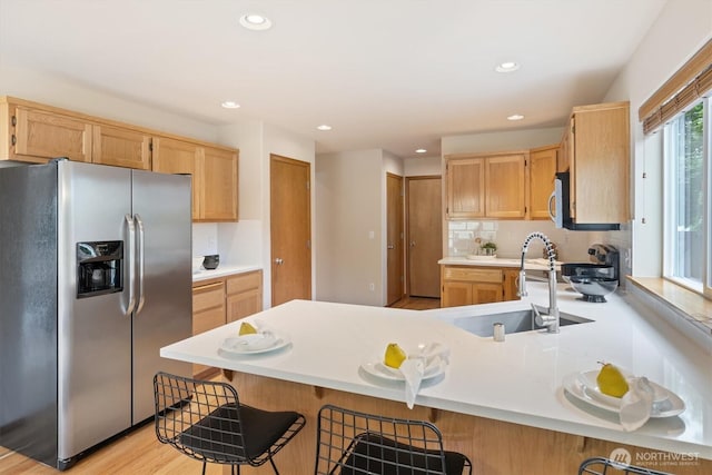 817 Darwins Way, Granite Falls, WA 98252 - kitchen with stainless steel appliances, a peninsula, light brown cabinetry, recessed lighting, and light countertops