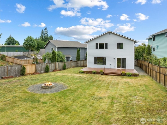 817 Darwins Way, Granite Falls, WA 98252 - rear view of house featuring an outdoor fire pit, a deck, and a fenced backyard