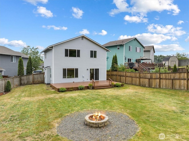 817 Darwins Way, Granite Falls, WA 98252 - rear view of house with a deck, a fenced backyard, and a fire pit