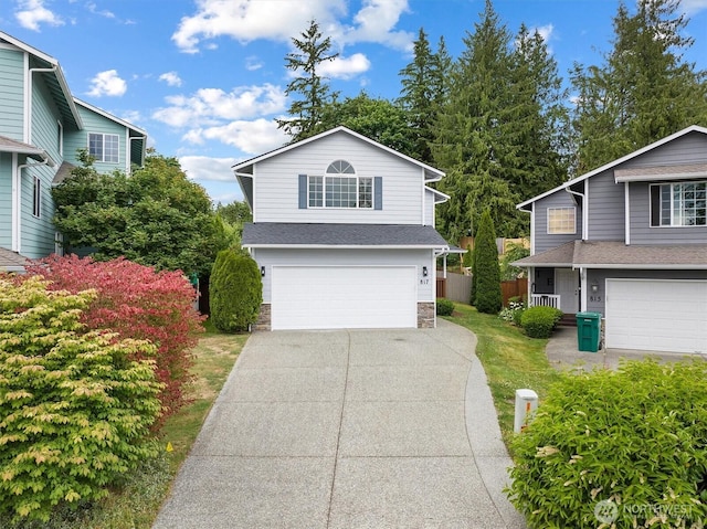 817 Darwins Way, Granite Falls, WA 98252 - traditional home with an attached garage, stone siding, and concrete driveway