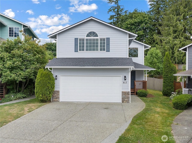 817 Darwins Way, Granite Falls, WA 98252 - traditional-style house featuring stone siding, concrete driveway, an attached garage, and a shingled roof
