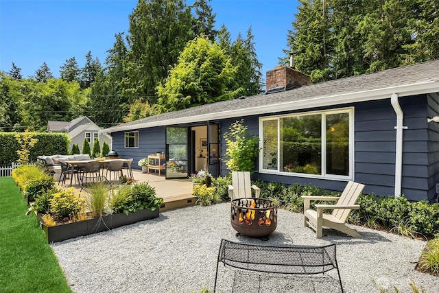 10430 NE Cascade St, Bainbridge Island, WA 98110 - rear view of property with an outdoor fire pit, a chimney, and a patio area