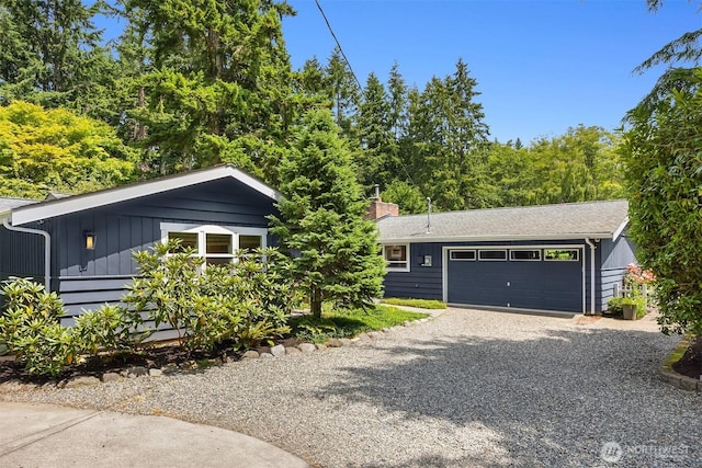 10430 NE Cascade St, Bainbridge Island, WA 98110 - view of front of home with board and batten siding, driveway, and an attached garage