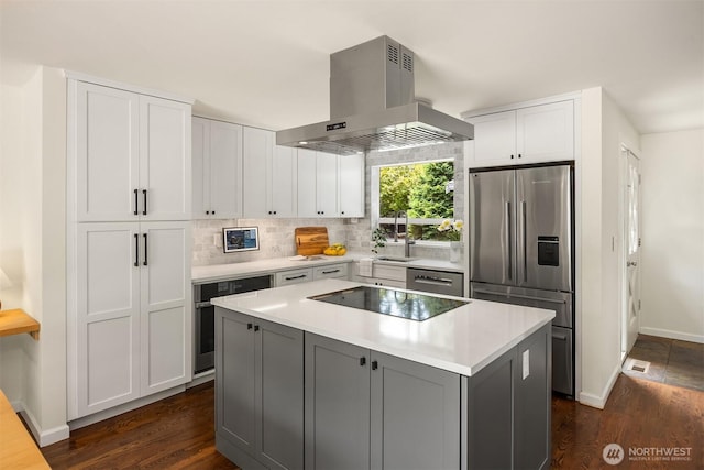 10430 NE Cascade St, Bainbridge Island, WA 98110 - kitchen featuring stainless steel appliances, island range hood, light countertops, and dark wood finished floors