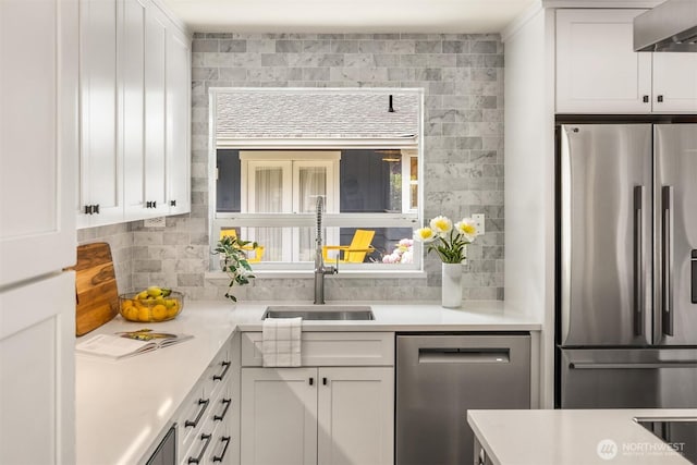 10430 NE Cascade St, Bainbridge Island, WA 98110 - kitchen featuring stainless steel appliances, wall chimney range hood, backsplash, white cabinetry, and light countertops