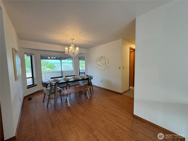 18509 22nd Ave E, Tacoma, WA 98445 - dining space featuring a chandelier, wood finished floors, and a textured wall