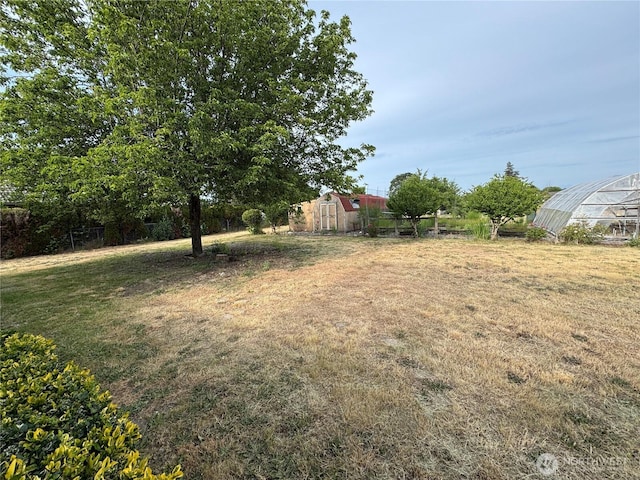 18509 22nd Ave E, Tacoma, WA 98445 - view of green lawn with an outbuilding and a greenhouse
