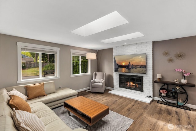 22625 1st Dr SE, Bothell, WA 98021 - living area with a skylight, a brick fireplace, and wood finished floors