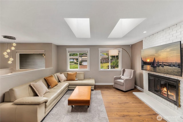 22625 1st Dr SE, Bothell, WA 98021 - living room with a skylight, wood finished floors, and a large fireplace