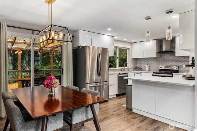 22625 1st Dr SE, Bothell, WA 98021 - kitchen featuring appliances with stainless steel finishes, wall chimney exhaust hood, modern cabinets, white cabinetry, and light countertops