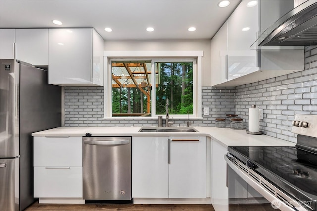 22625 1st Dr SE, Bothell, WA 98021 - kitchen with appliances with stainless steel finishes, exhaust hood, white cabinets, light countertops, and decorative backsplash