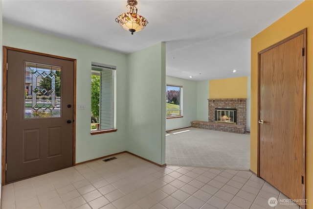 2338 Grand Ave, East Wenatchee, WA 98802 - foyer entrance featuring light carpet, light tile patterned flooring, a fireplace, and recessed lighting