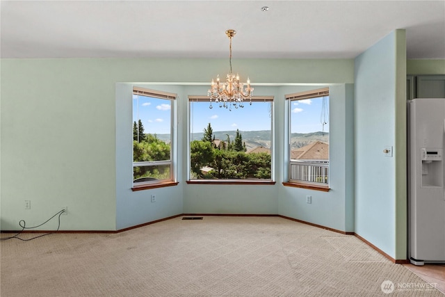 2338 Grand Ave, East Wenatchee, WA 98802 - unfurnished dining area featuring a chandelier and carpet flooring
