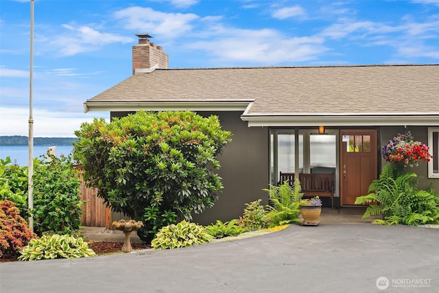 21553 1st Ct S, Normandy Park, WA 98198 - property entrance featuring a shingled roof, a chimney, and a water view