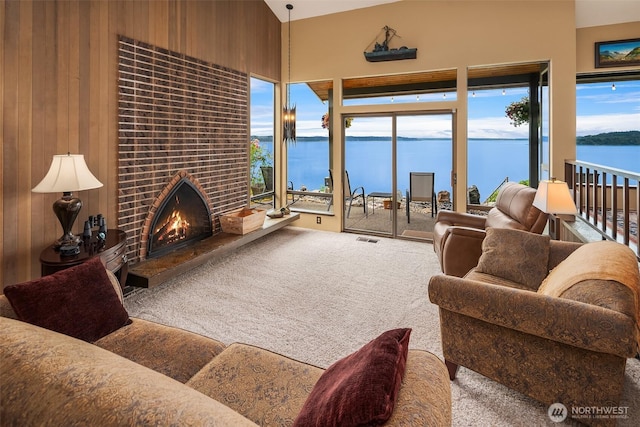 21553 1st Ct S, Normandy Park, WA 98198 - carpeted living area featuring a water view, a fireplace, and wood walls