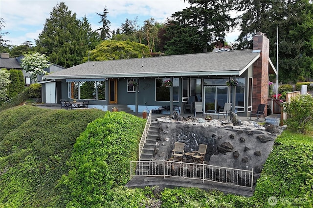 21553 1st Ct S, Normandy Park, WA 98198 - back of house with a patio area, a chimney, and roof with shingles
