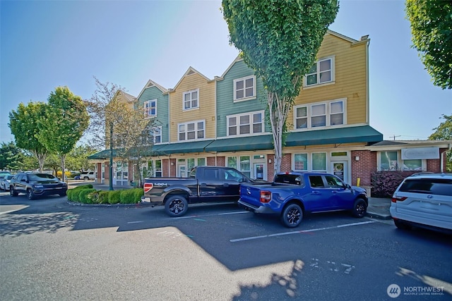 816 Cherry Ave, Sumner, WA 98390 - townhome / multi-family property featuring brick siding and uncovered parking