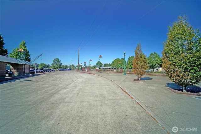 816 Cherry Ave, Sumner, WA 98390 - view of concrete road with curbs, street lights, and sidewalks