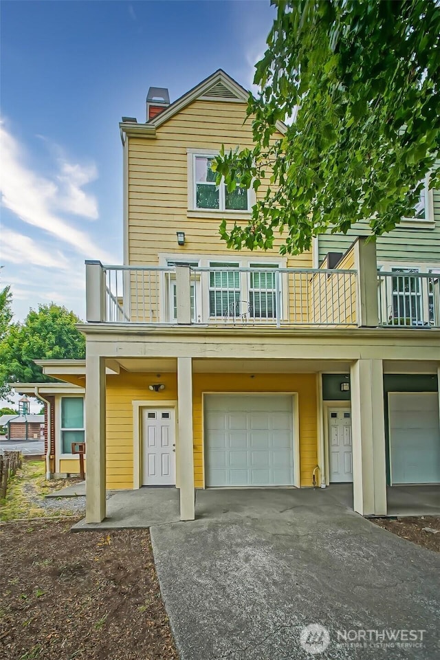 816 Cherry Ave, Sumner, WA 98390 - multi unit property with an attached garage, a balcony, driveway, and a chimney