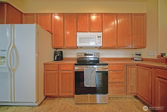 816 Cherry Ave, Sumner, WA 98390 - kitchen with white appliances, light countertops, and brown cabinetry