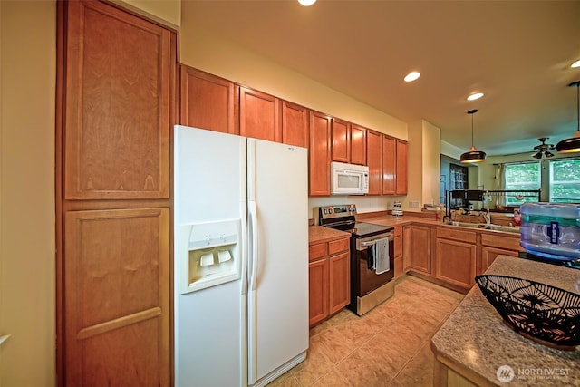 816 Cherry Ave, Sumner, WA 98390 - kitchen featuring white appliances, brown cabinetry, recessed lighting, light tile patterned floors, and hanging light fixtures