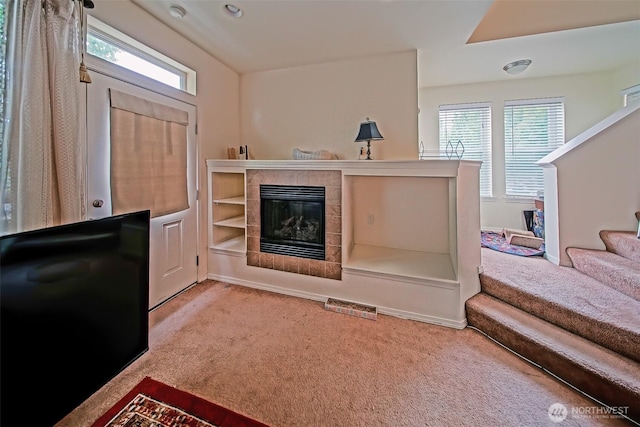 816 Cherry Ave, Sumner, WA 98390 - living room with carpet floors, healthy amount of natural light, a tile fireplace, and stairway