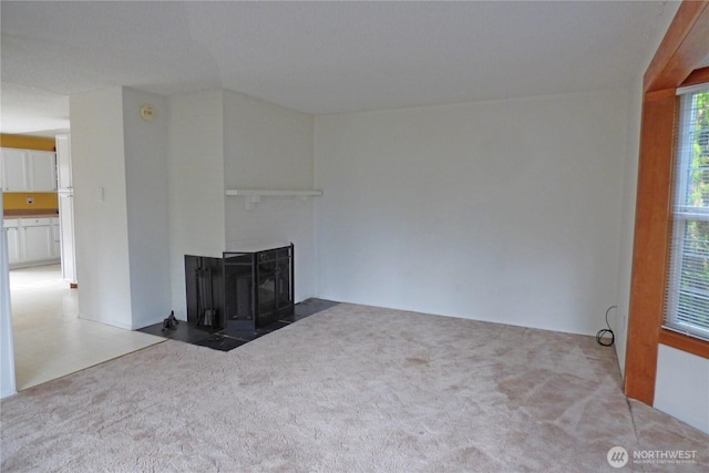 8703 Skokomish Way NE, Olympia, WA 98516 - unfurnished living room featuring a multi sided fireplace and carpet