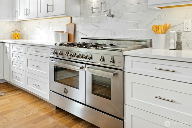 6686 NE Ralston Rd, Bainbridge Island, WA 98110 - kitchen with range with two ovens, backsplash, and light countertops