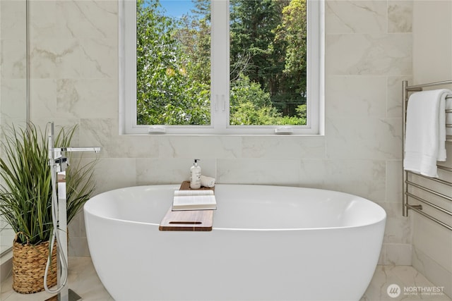 6686 NE Ralston Rd, Bainbridge Island, WA 98110 - bathroom with plenty of natural light, a freestanding tub, and tile walls