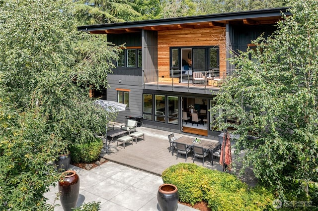 6686 NE Ralston Rd, Bainbridge Island, WA 98110 - rear view of property with a balcony, a patio area, and outdoor dining area