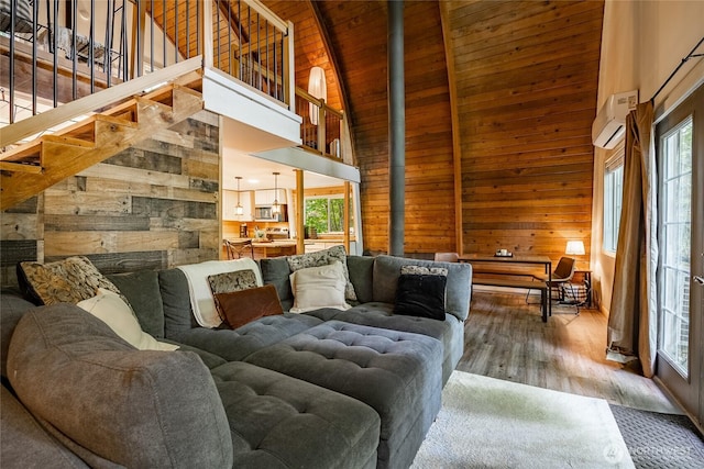 14001 Welcome Rd, Glacier, WA 98244 - living room with wooden walls, high vaulted ceiling, a wooden ceiling with exposed beams, a wall mounted AC, and wood finished floors