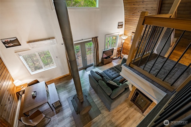 14001 Welcome Rd, Glacier, WA 98244 - living area featuring a high ceiling, wood finished floors, wooden walls, stairs, and french doors