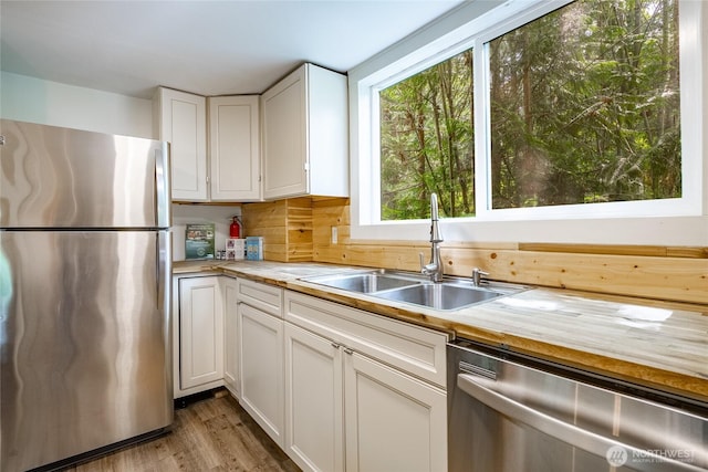 14001 Welcome Rd, Glacier, WA 98244 - kitchen with stainless steel appliances, wood counters, white cabinets, and wood finished floors
