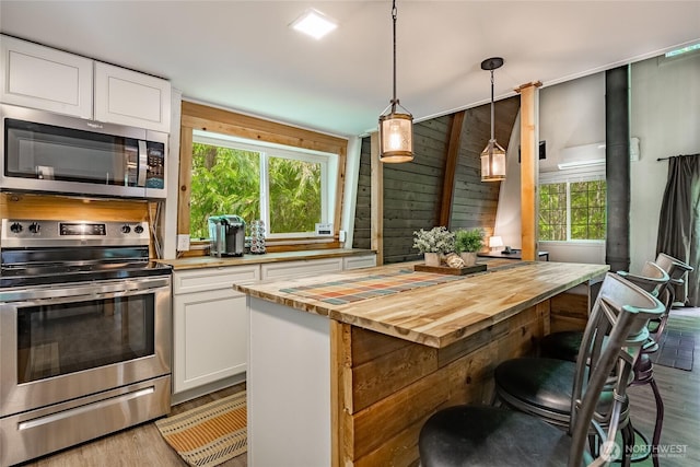 14001 Welcome Rd, Glacier, WA 98244 - kitchen with appliances with stainless steel finishes, light wood finished floors, wood counters, and white cabinets