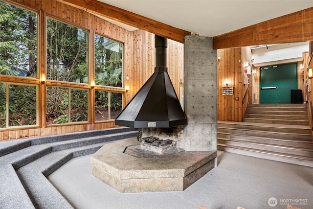 14001 Welcome Rd, Glacier, WA 98244 - living area with wooden walls, carpet flooring, a wood stove, and stairs
