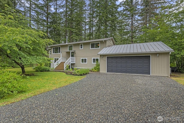 17225 429th Ave SE, North Bend, WA 98045 - split foyer home featuring view of scattered trees, a front yard, gravel driveway, an attached garage, and stairway