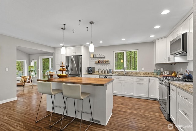 17225 429th Ave SE, North Bend, WA 98045 - kitchen with stainless steel appliances, wood counters, dark wood-type flooring, white cabinetry, and recessed lighting