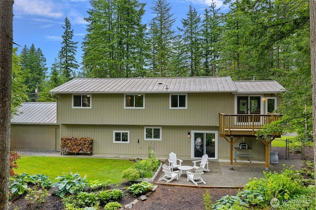 17225 429th Ave SE, North Bend, WA 98045 - rear view of house featuring a metal roof, a patio area, and a yard