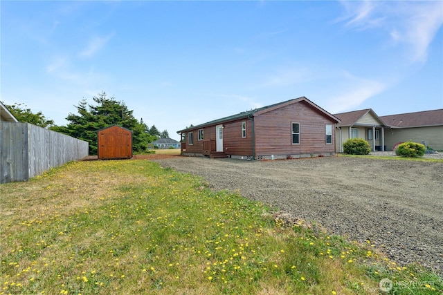 276 Canal Dr NE, Ocean Shores, WA 98569 - view of side of property with a shed, driveway, and entry steps