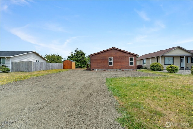276 Canal Dr NE, Ocean Shores, WA 98569 - view of property exterior with a shed and dirt driveway
