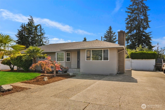 14715 57th Ave S, Tukwila, WA 98168 - view of front facade featuring a chimney and roof with shingles