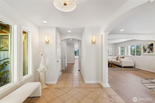 7001 Palm Ln, Anacortes, WA 98221 - corridor featuring light tile patterned floors, arched walkways, recessed lighting, and decorative columns